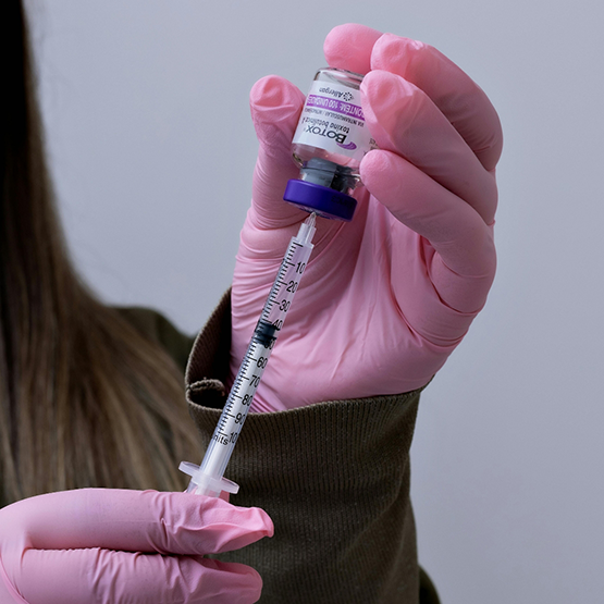 Dentist drawing a syringe of Botox