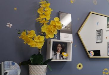Wall in treatment room with sunflower themed artwork