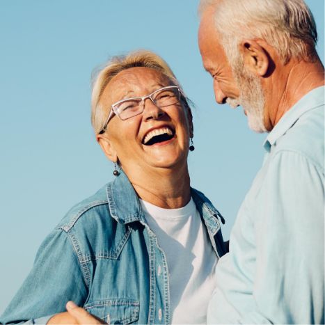 Senior couple laughing together outdoors